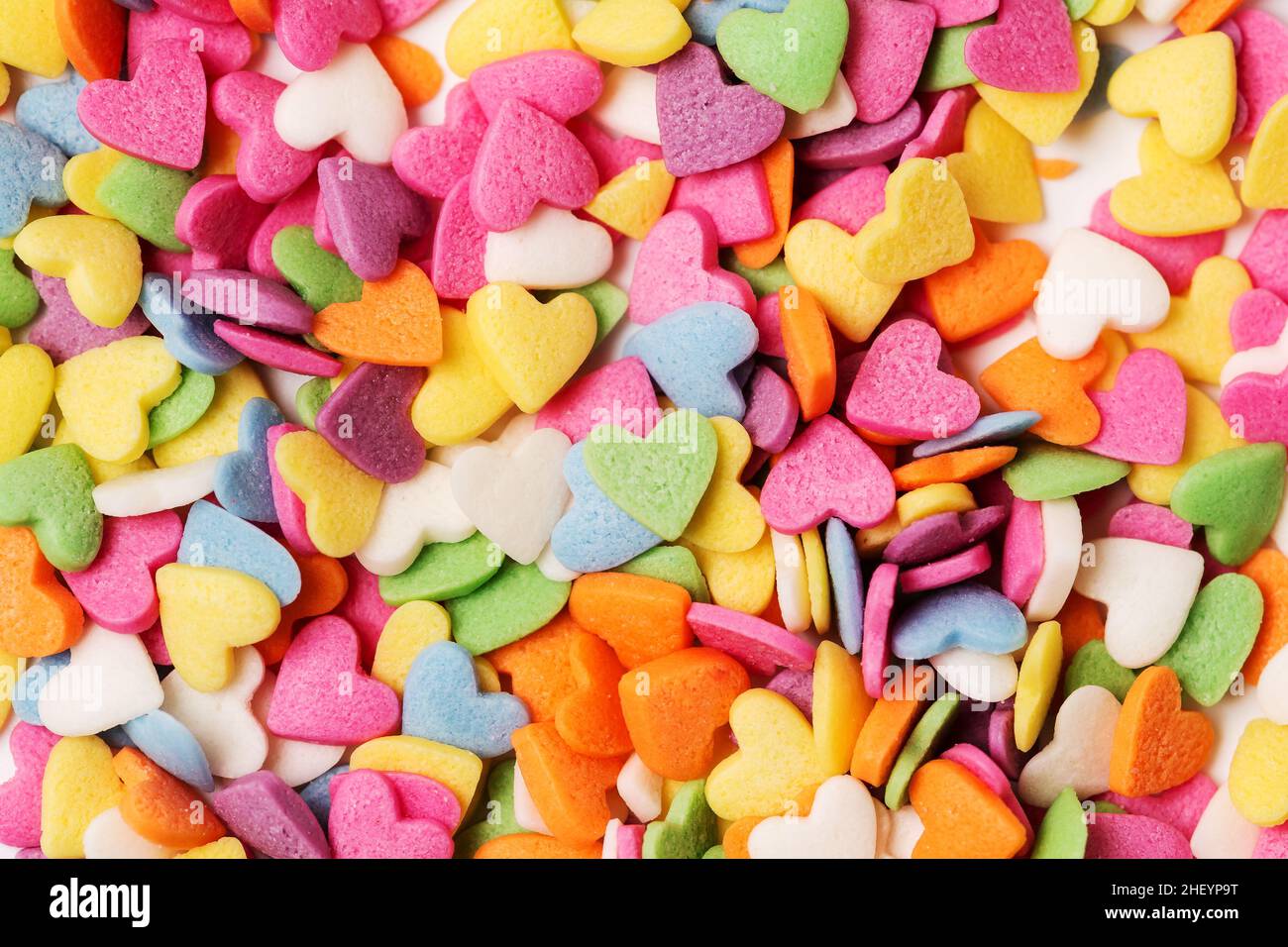 Multi-colored heart-shaped pastry topping sprinkles close-up minimalistic saint valentine`s day greeting card Stock Photo